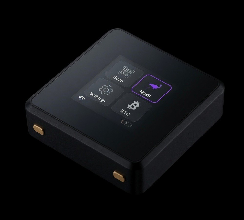 Favilla KEY — black anodised aluminium device, screen showing the Nostr, Bitcoin, Scan and Settings menu